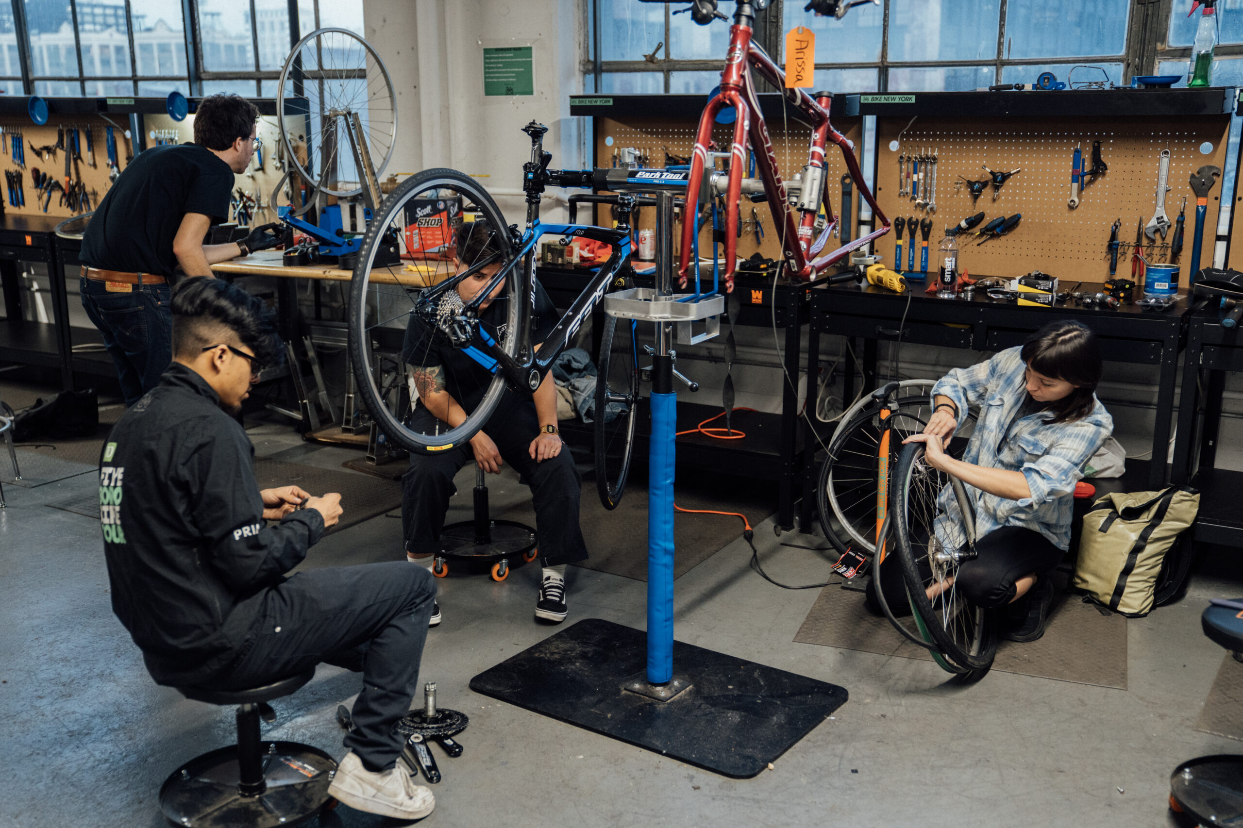 Bicycle repair workshop equipped with tools, spare parts, and a bike ready for servicing