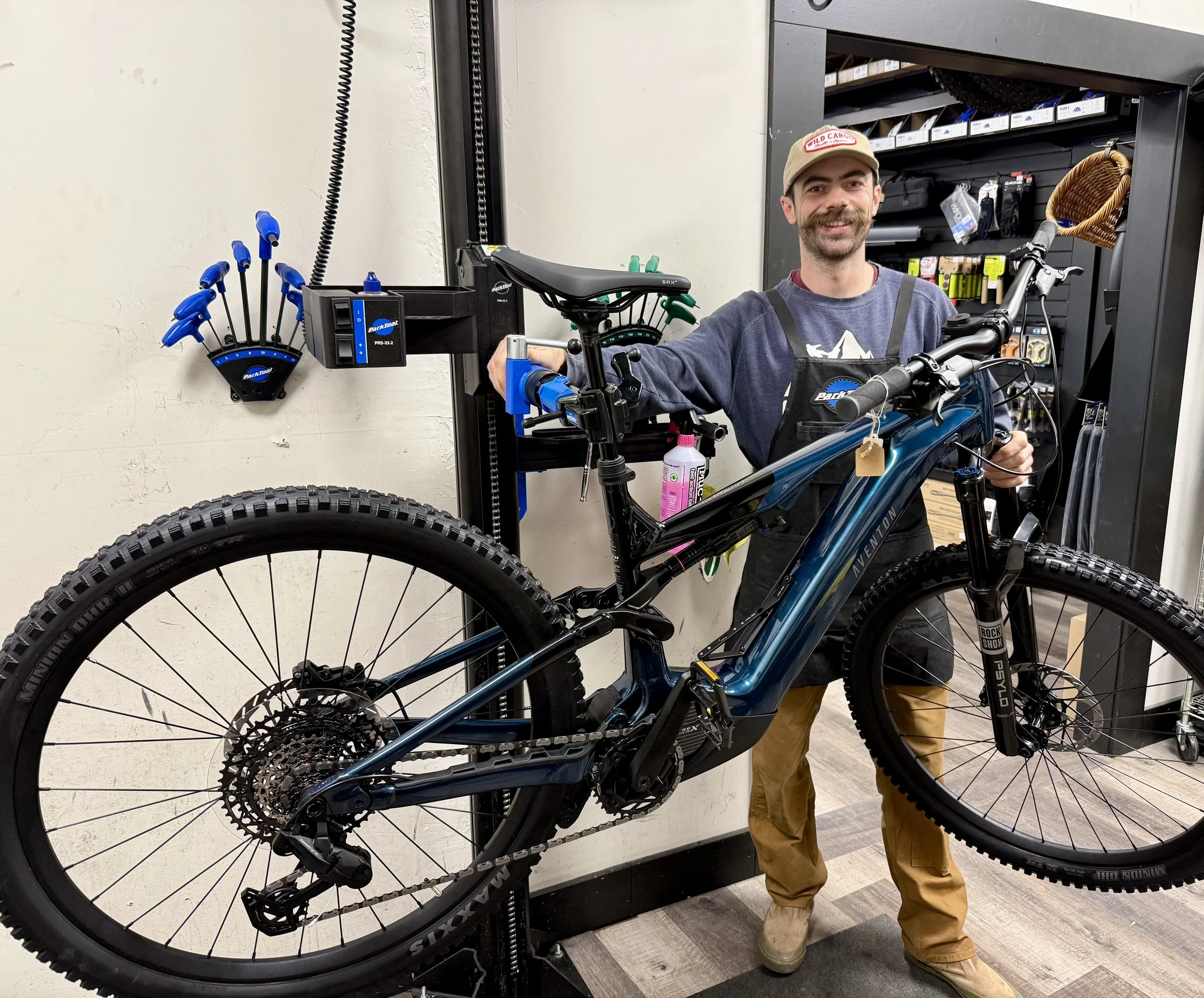 Mechanic inspecting bicycle gears and adjusting components during a service